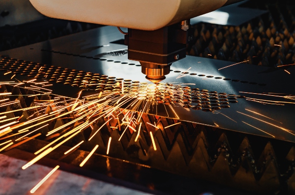 A sheet metal fabrication tool cuts holes in a sheet during production.