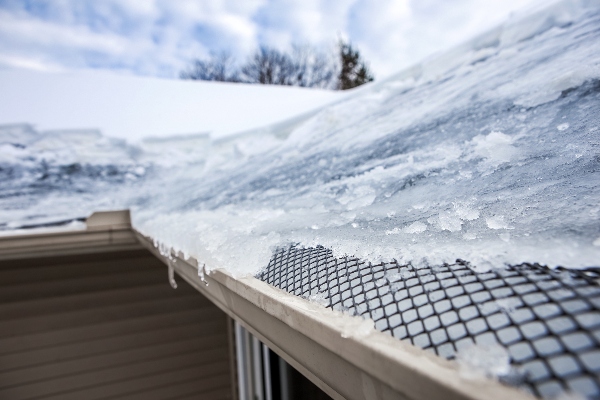 An ice-filled gutter will not protect your home during the winter.
